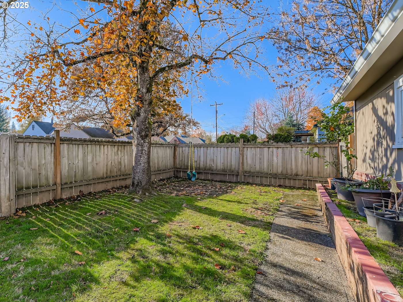 12025 Southwest 9th Street Beaverton, OR 97005 - Photo 20 of 22 a view of a backyard with wooden fence and a large tree