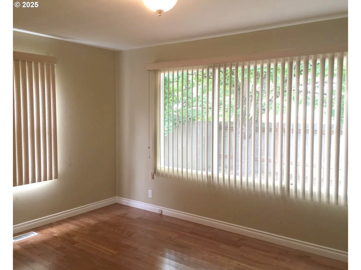 12025 Southwest 9th Street Beaverton, OR 97005 - Photo 5 of 22 a view of an empty room with wooden floor and a window