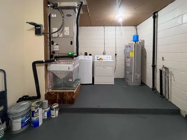 a utility room with multiple dryer and washer