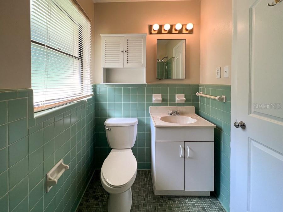3920 Southwest 21st Street Gainesville, FL 32608 - Photo 25 of 40 a bathroom with a toilet sink and mirror