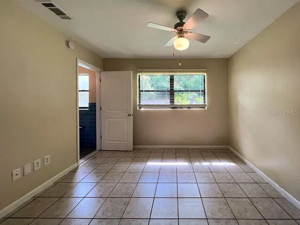 a view of an empty room and a window