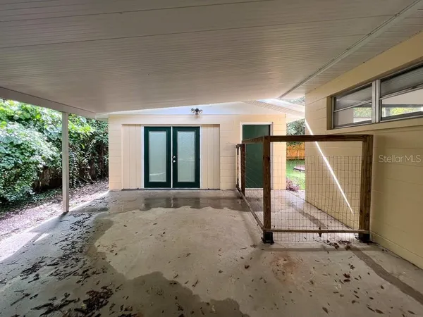 an empty room with a wooden floor and windows