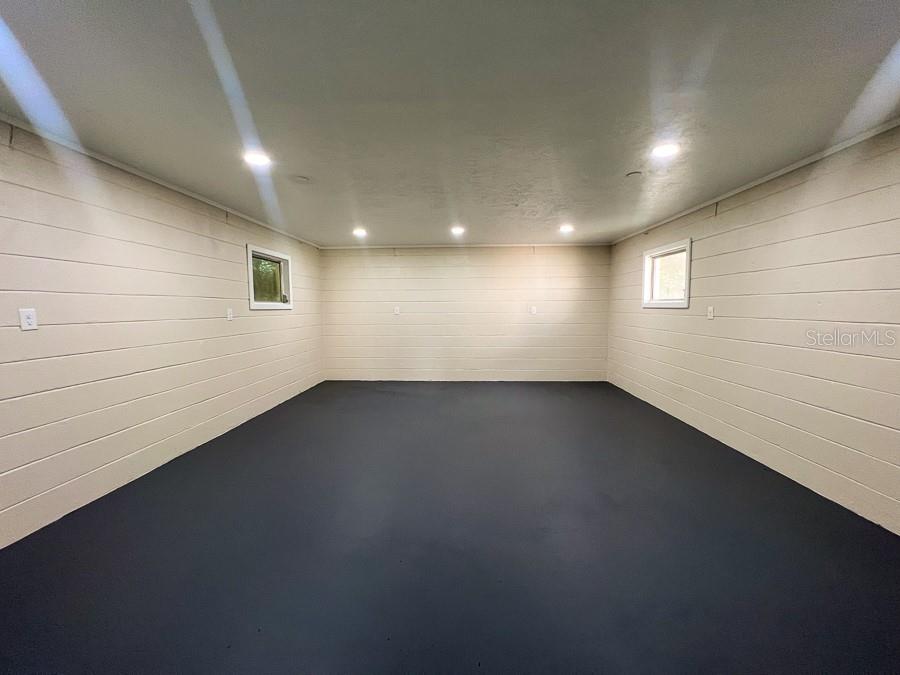 3920 Southwest 21st Street Gainesville, FL 32608 - Photo 34 of 40 an empty room with a wooden floor and windows