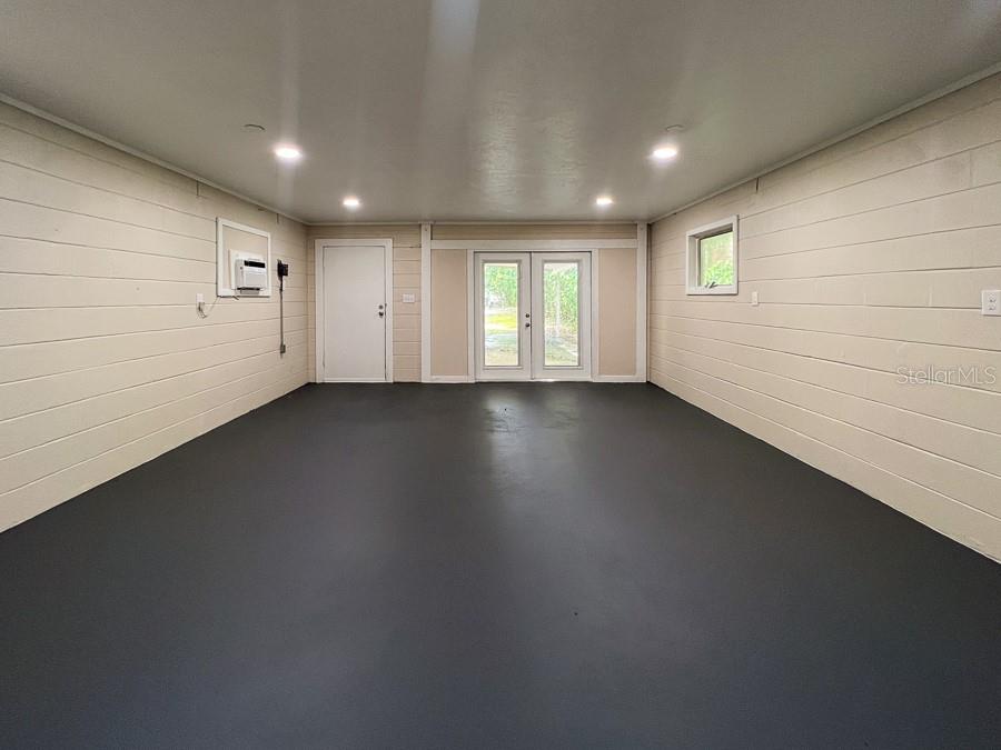 3920 Southwest 21st Street Gainesville, FL 32608 - Photo 35 of 40 an empty room with wooden floor and windows