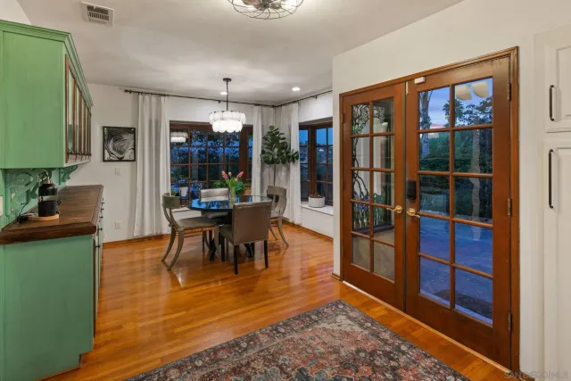 a large kitchen with kitchen island a large window and stainless steel appliances