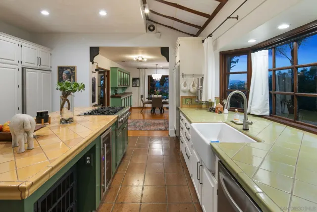 a dining room with furniture a large window and wooden floor
