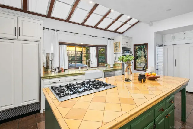 a dining room with furniture a chandelier and wooden floor
