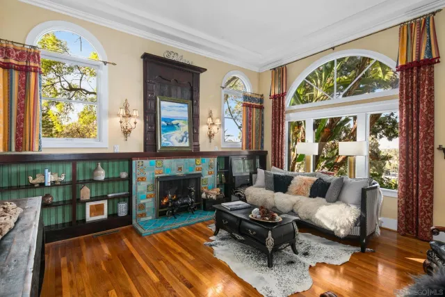 a view of a living room with furniture and floor to ceiling window