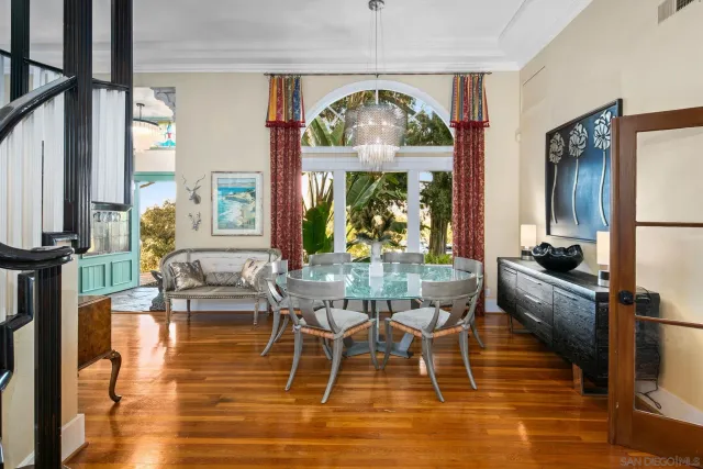 a view of a dining room with furniture a chandelier and wooden floor