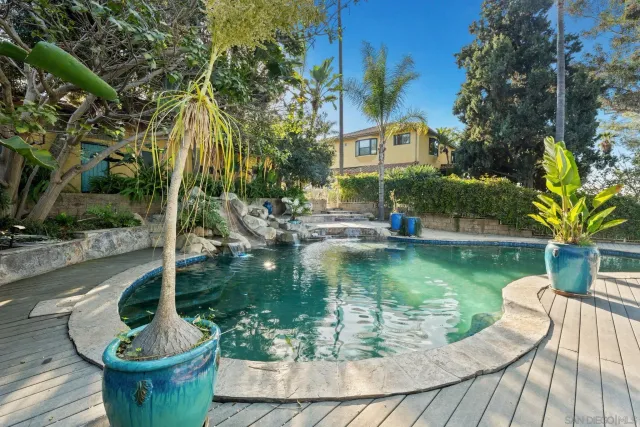 a view of a tables and chairs in a backyard
