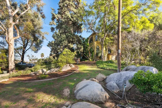 a bedroom with a bed and a dresser next to a window