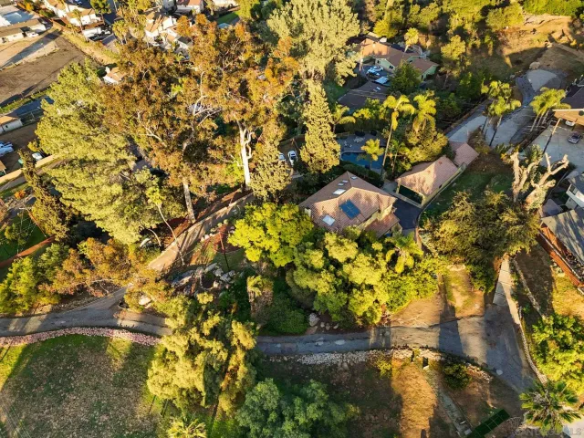 an aerial view of a house with a yard swimming pool and outdoor seating