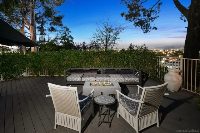 a dining room with wooden floor a glass table and chairs