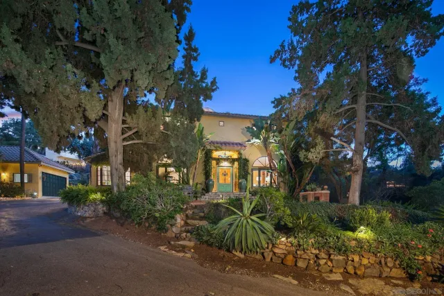a living room with furniture a fireplace and large windows