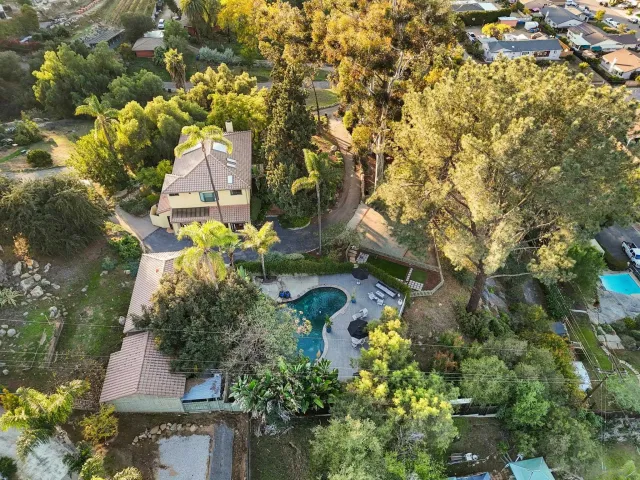 a living room with furniture a fireplace and a floor to ceiling window
