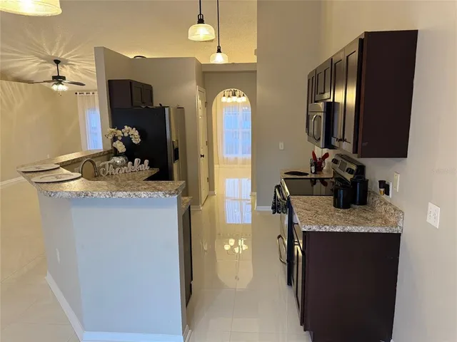 a bathroom with a granite countertop sink a mirror and vanity