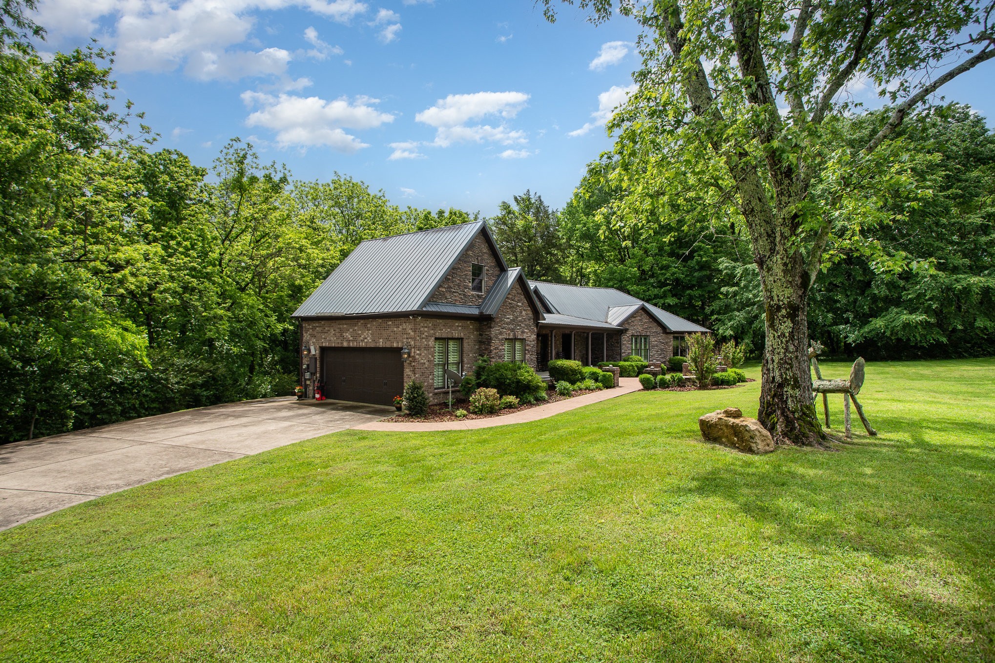 884 Pinnacle Hill Road Kingston Springs, TN 37082 - Photo 3 of 55 a front view of a house with a yard and trees