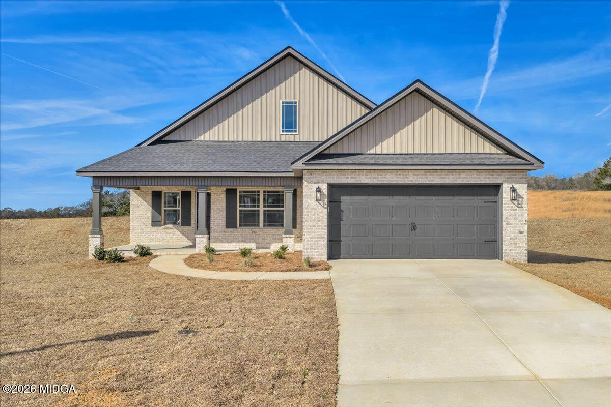 104 Early Drive Byron, GA 31008 - Photo 2 of 58 a front view of a house with a yard outdoor seating and garage