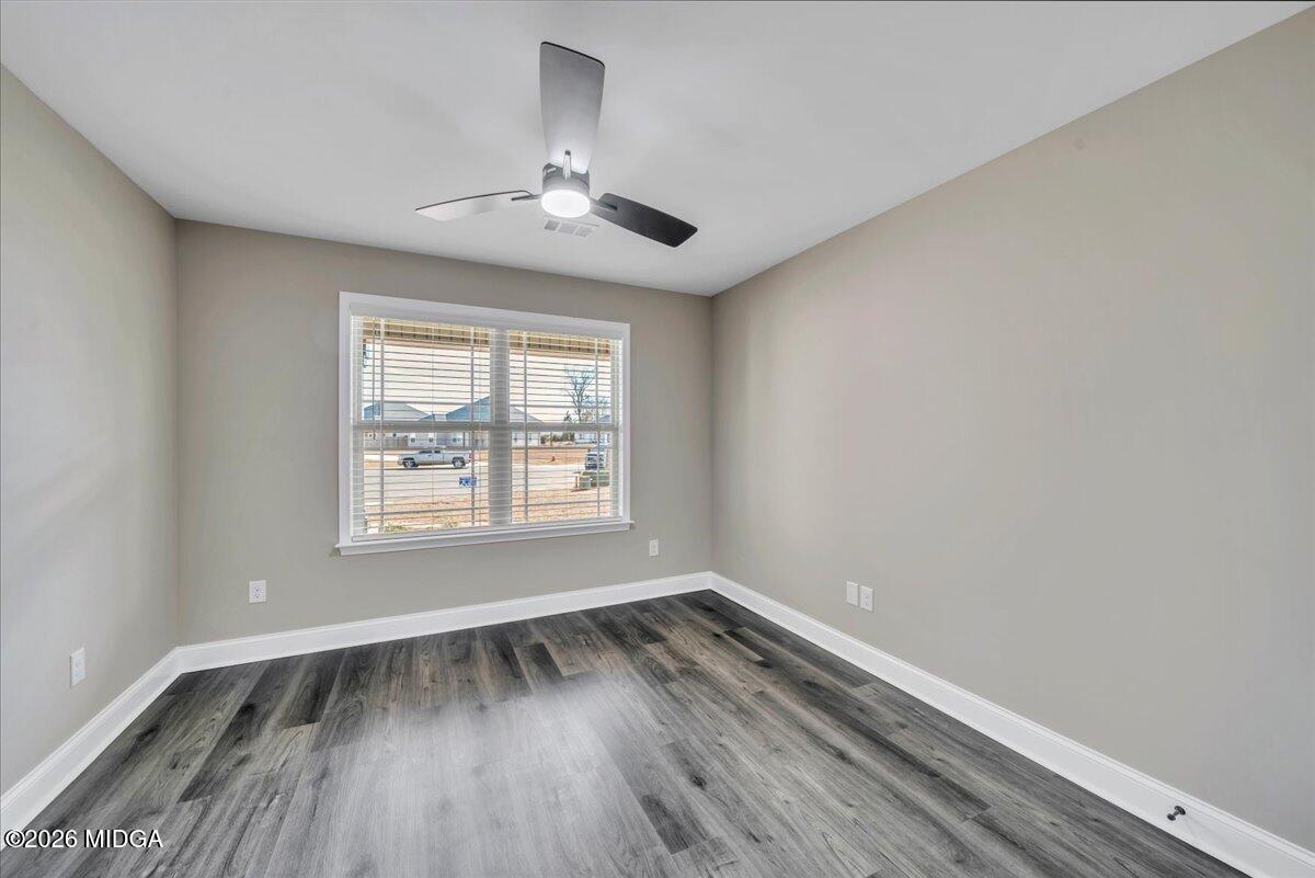 104 Early Drive Byron, GA 31008 - Photo 44 of 58 a view of an empty room with wooden floor and a window