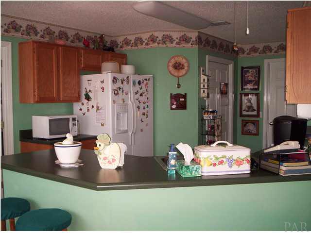6755 Cedar Ridge Circle Milton, FL 32570 - Photo 5 of 13 Kitchen and breakfast bar, looking toward front of home.