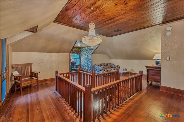 a bedroom with a bed and a mirror