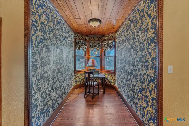 a view of a room with wooden floor