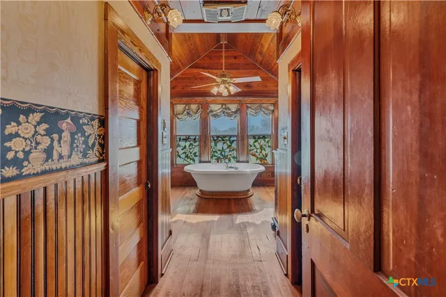 a spacious bathroom with a granite countertop sink a mirror and shower