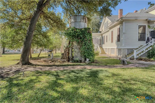 a view of a house with a yard garden and patio