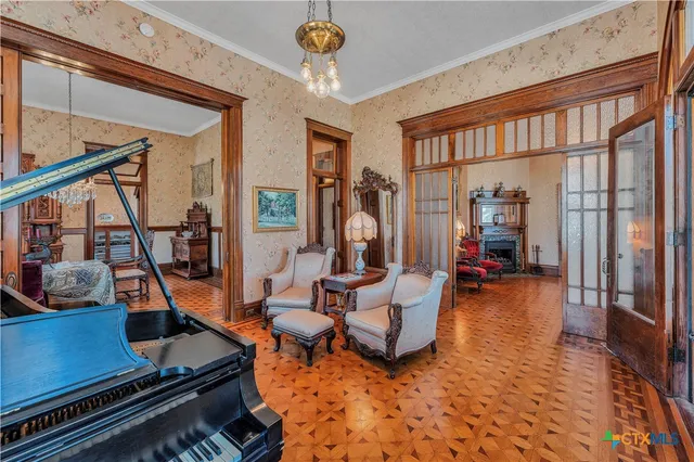 a room with lots of furniture and a chandelier