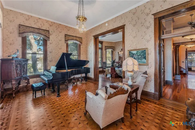 a living room with furniture a rug and a chandelier