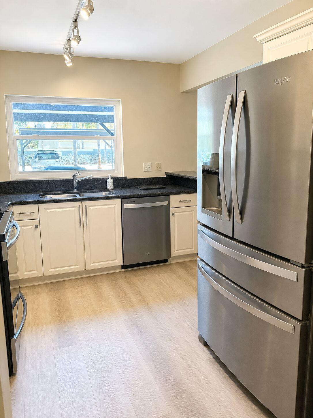 1871 Southwest Palm City Road, Unit G401 Stuart, FL 34994 - Photo 2 of 16 a kitchen with stainless steel appliances granite countertop a refrigerator and a stove