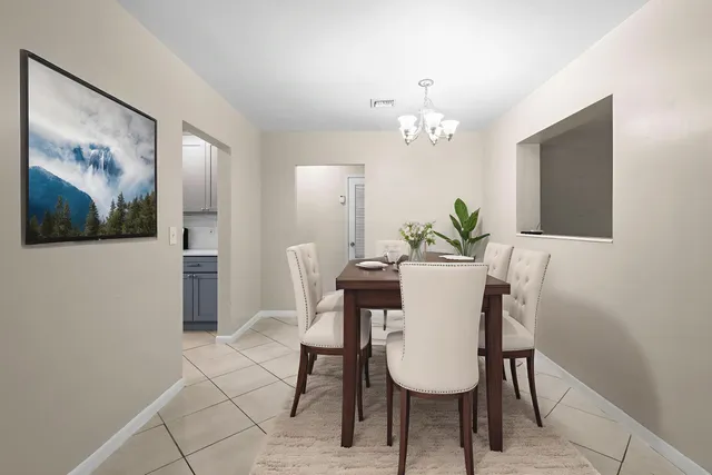 a view of a dining room with furniture and chandelier
