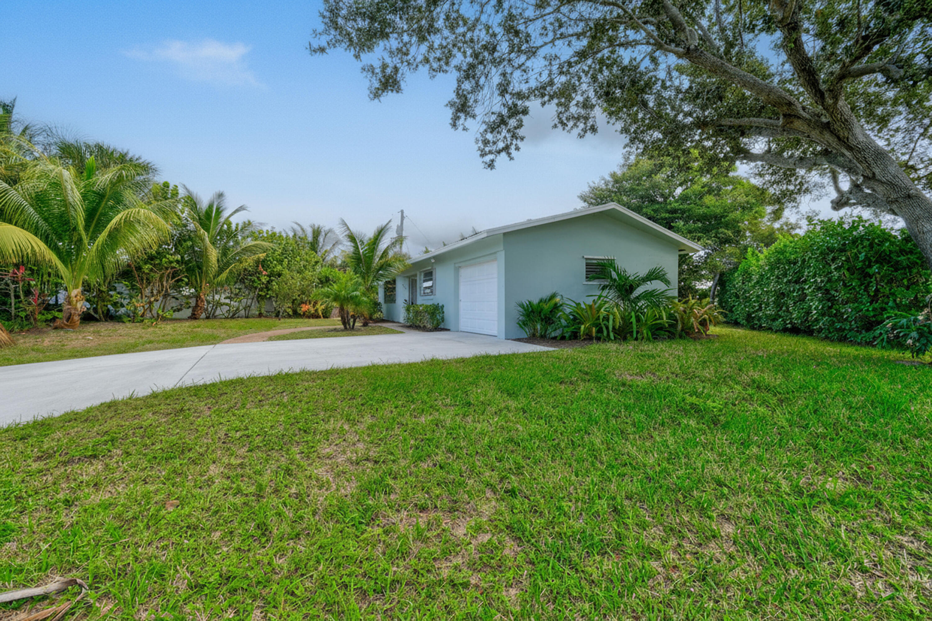 356 Cedar Avenue Tequesta, FL 33469 - Photo 2 of 51 a view of yard with small plants and palm trees
