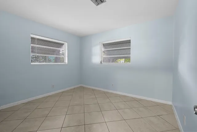 an empty room with windows and closet