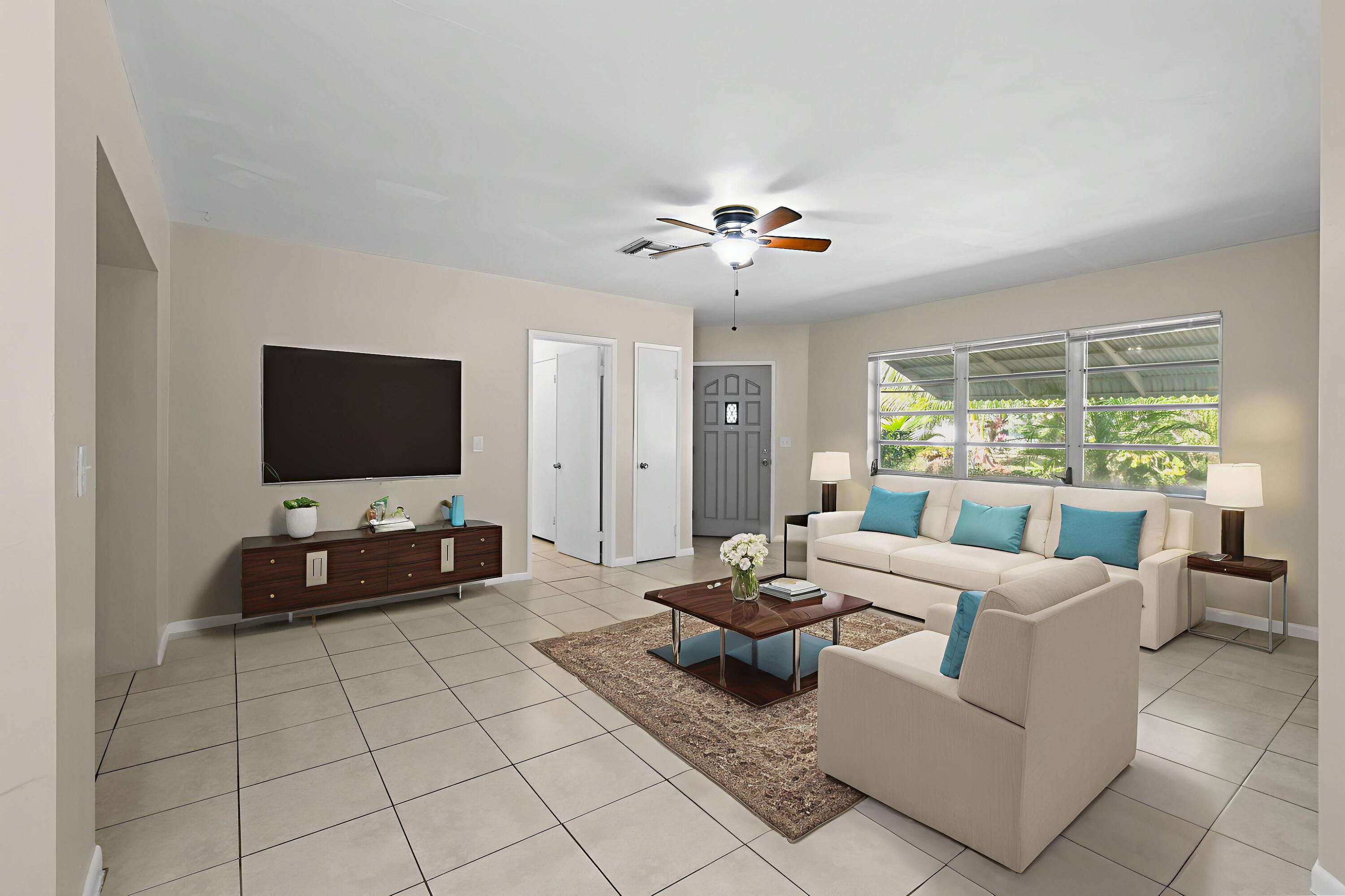 356 Cedar Avenue Tequesta, FL 33469 - Photo 10 of 51 a living room with furniture and a flat screen tv