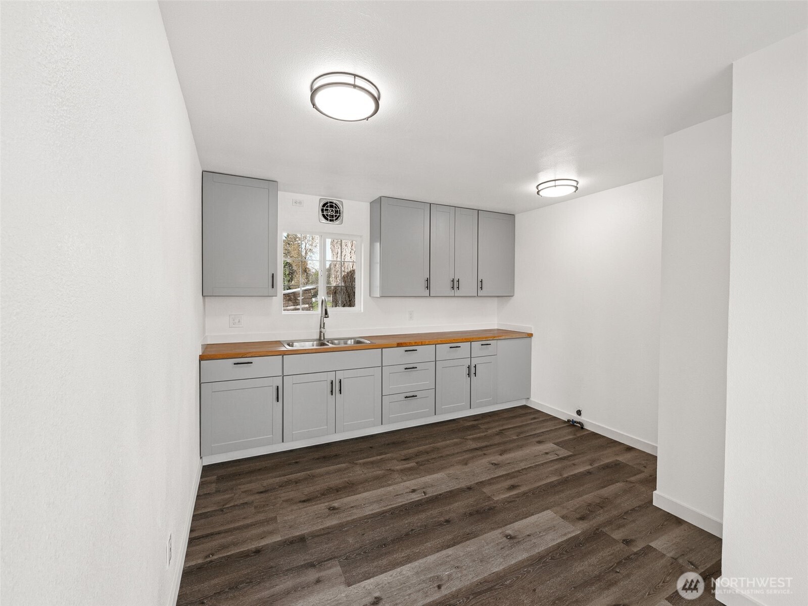 12535 Southeast Kent-Kangley Road Kent, WA 98030 - Photo 8 of 11 a room with a sink cabinets and wooden floor