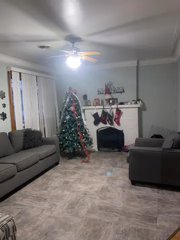 a living room with furniture and a chandelier