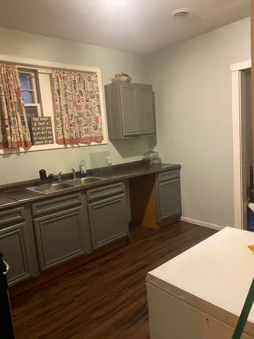 a kitchen with granite countertop a sink and a stove top oven