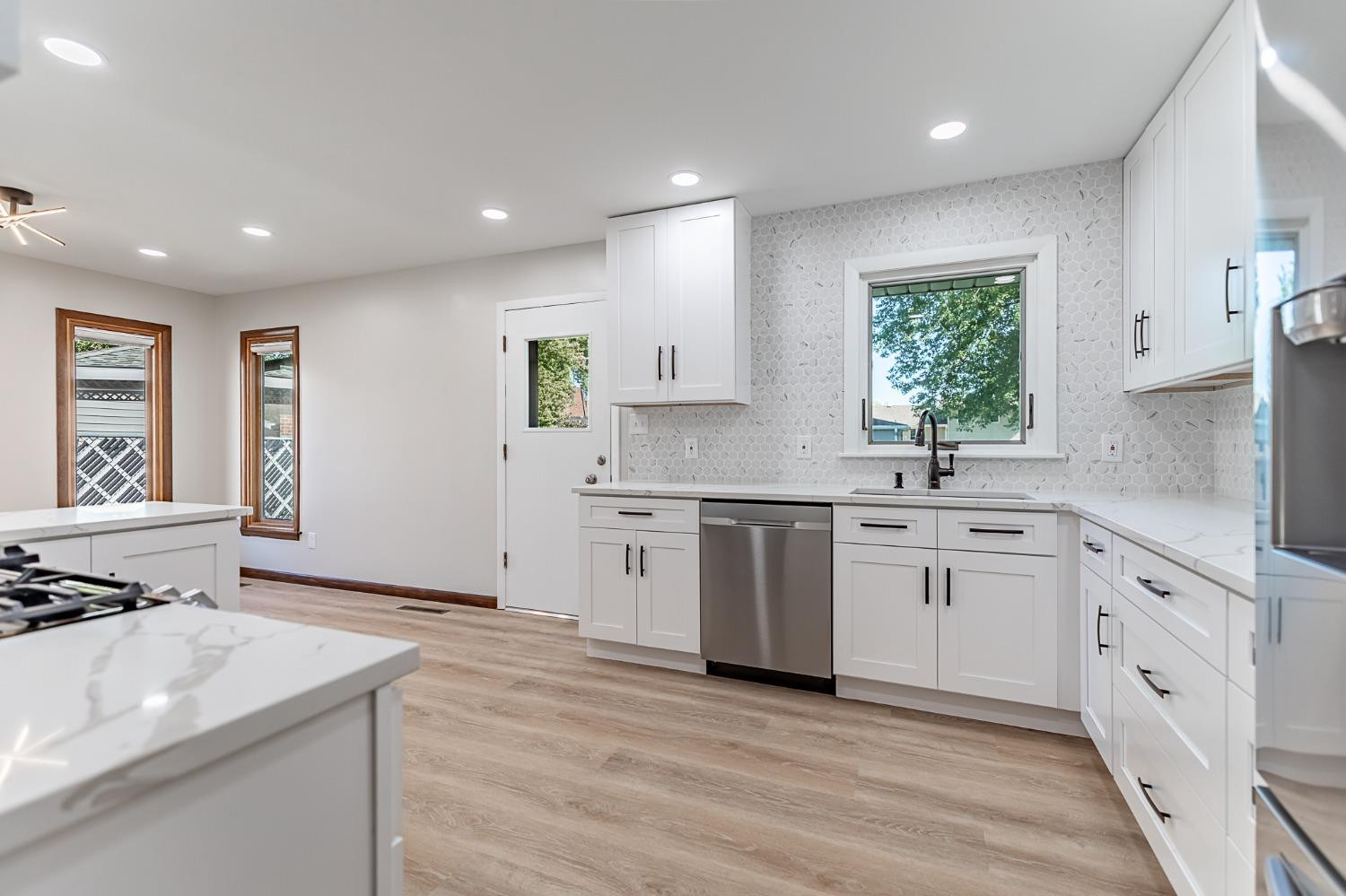 8551 Garfield Avenue Munster, IN 46321 - Photo 19 of 39 a kitchen with granite countertop white cabinets and white appliances