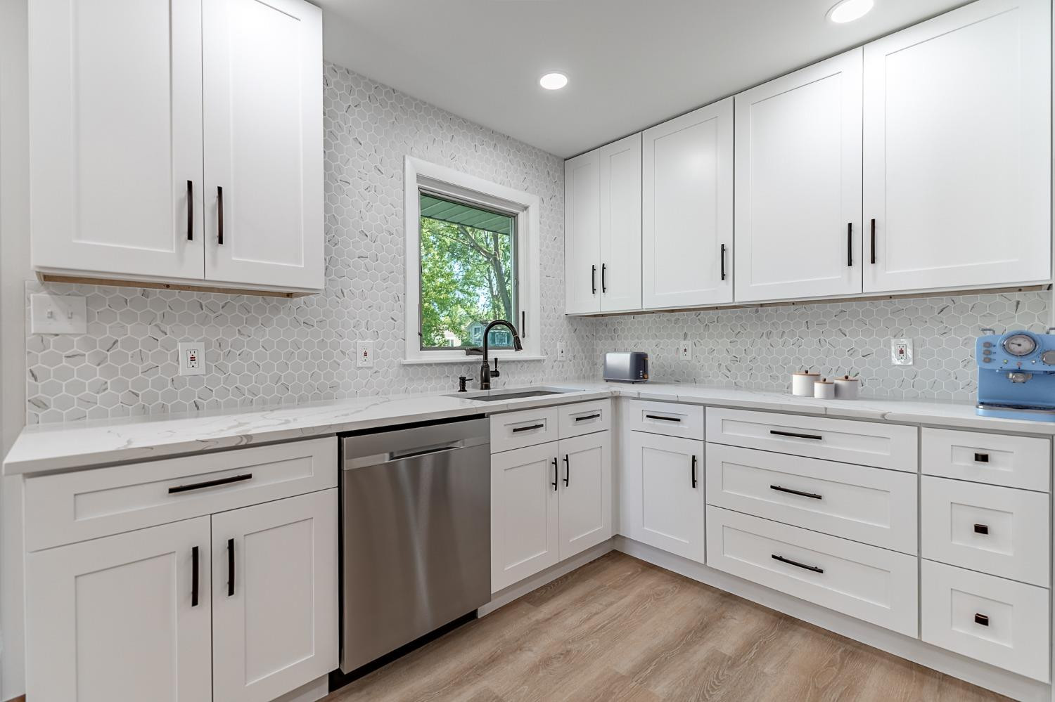 8551 Garfield Avenue Munster, IN 46321 - Photo 21 of 39 a kitchen with cabinets appliances a sink and a window