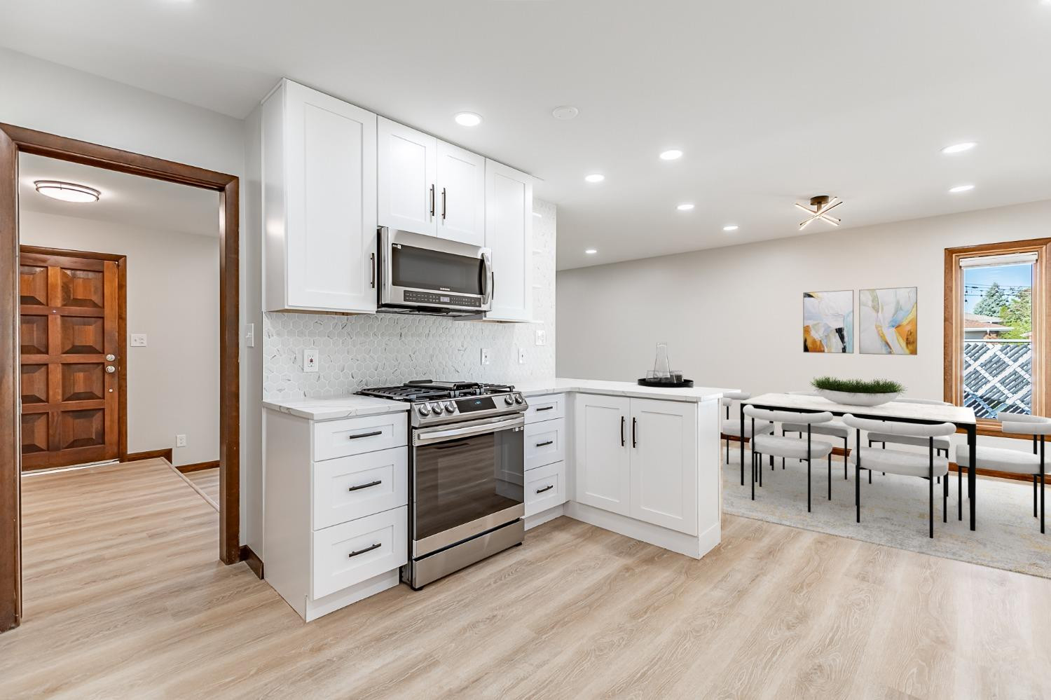 8551 Garfield Avenue Munster, IN 46321 - Photo 23 of 39 a kitchen with a stove a sink and a microwave