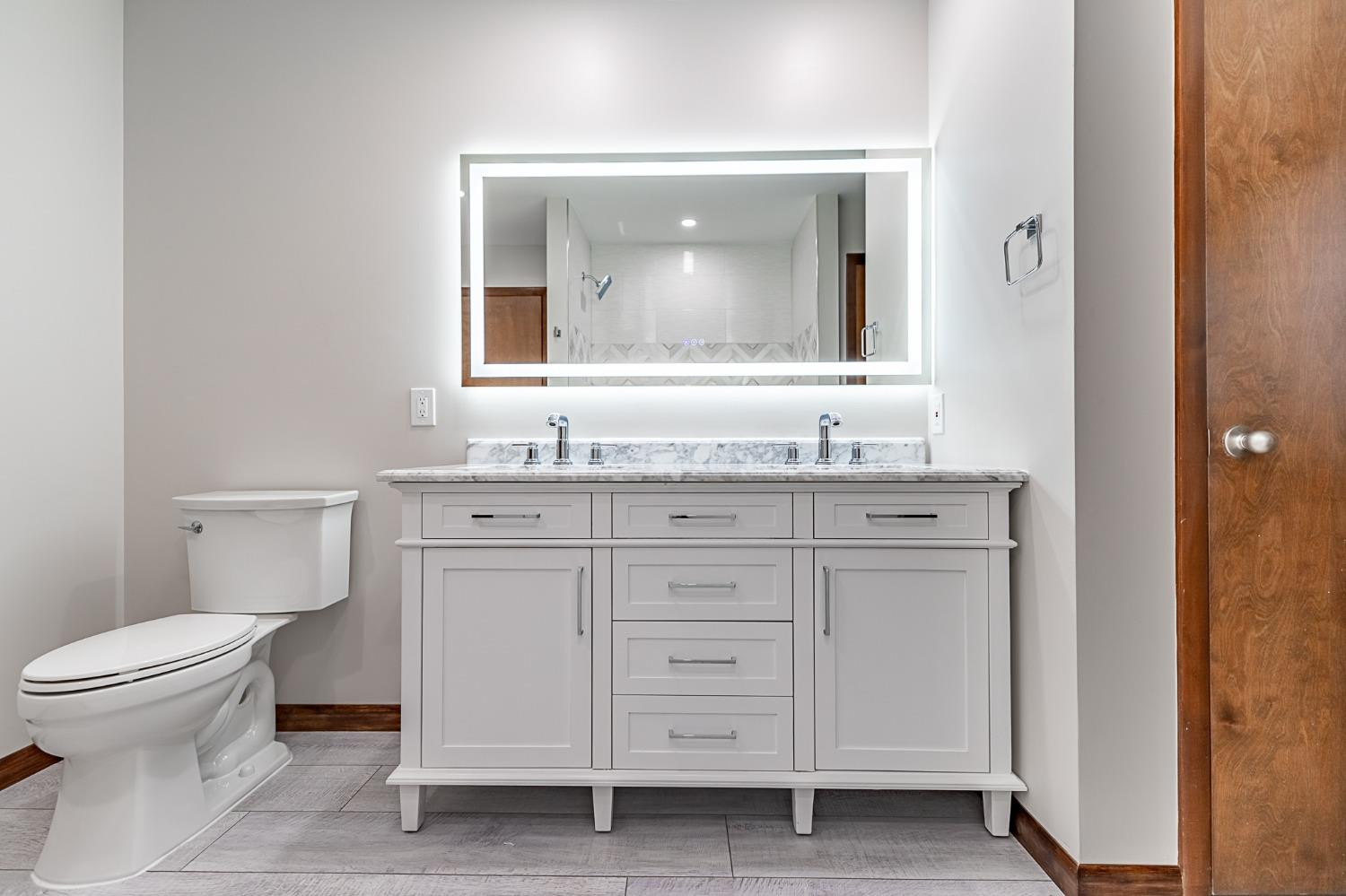 8551 Garfield Avenue Munster, IN 46321 - Photo 28 of 39 a bathroom with a granite countertop toilet sink and a mirror