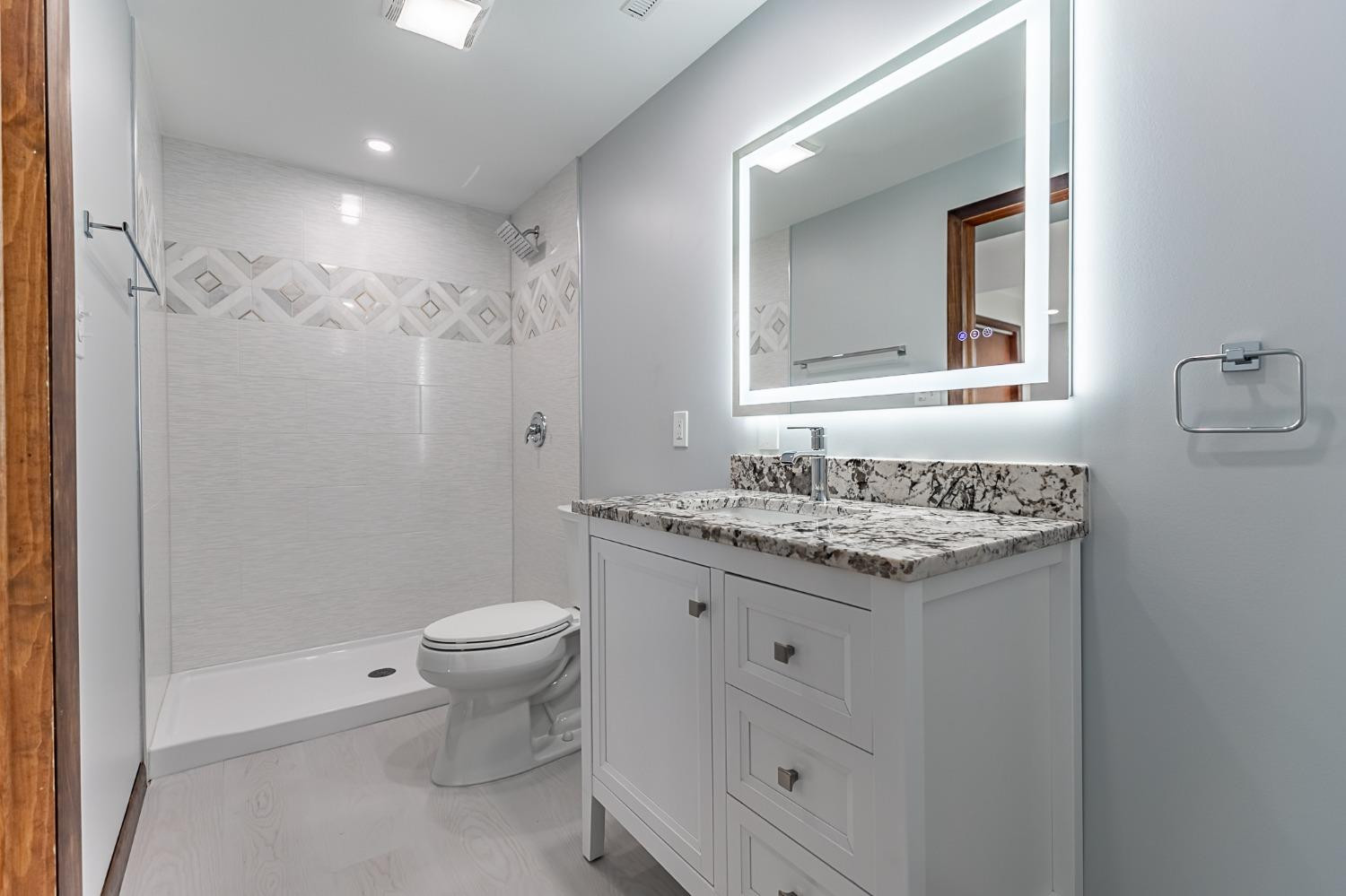 8551 Garfield Avenue Munster, IN 46321 - Photo 36 of 39 a bathroom with a granite countertop sink toilet and mirror