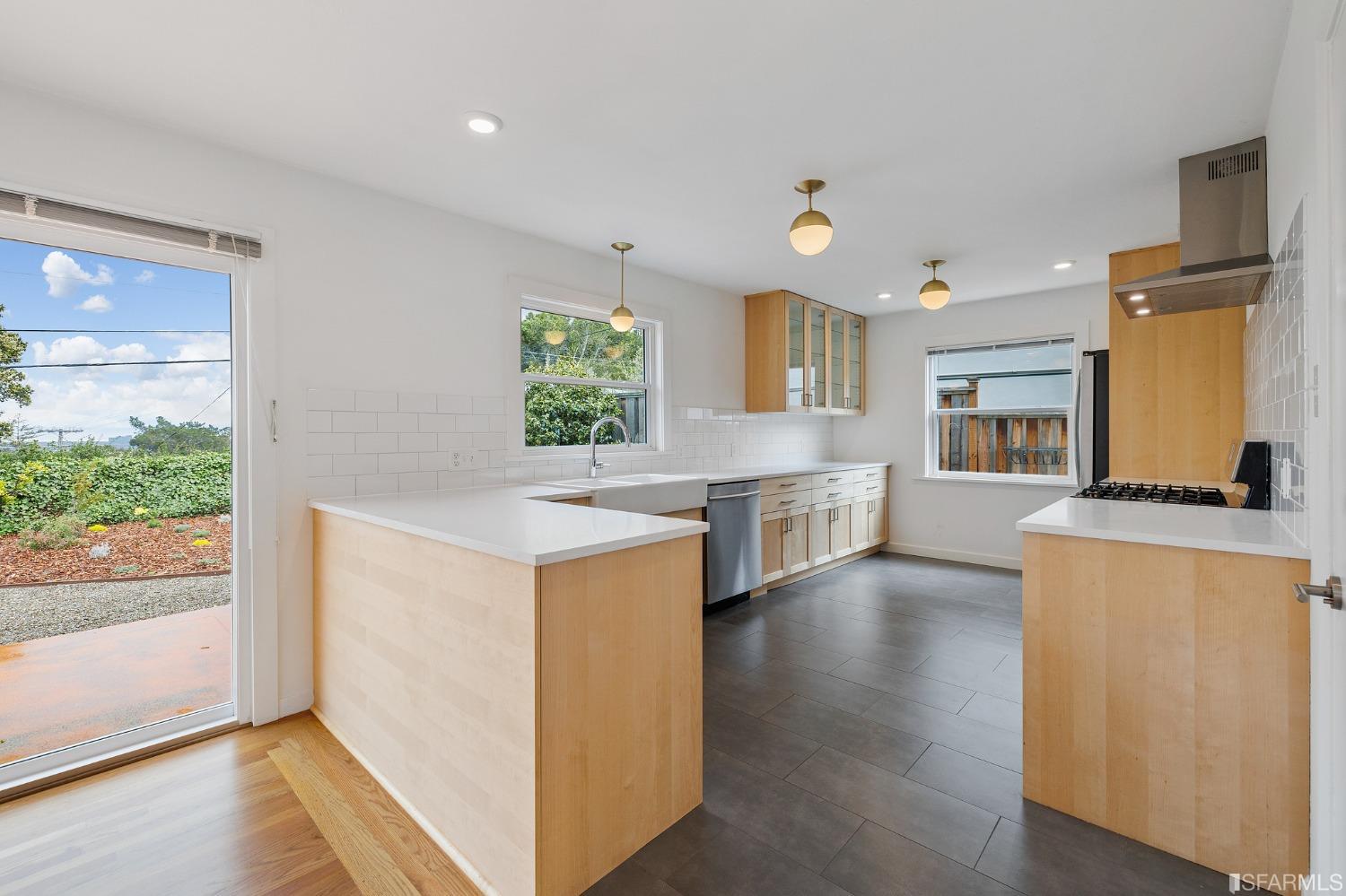 3101 Sunset Terrace San Mateo, CA 94403 - Photo 5 of 24 a kitchen with stainless steel appliances granite countertop a refrigerator a stove top oven a sink and dishwasher with wooden floor