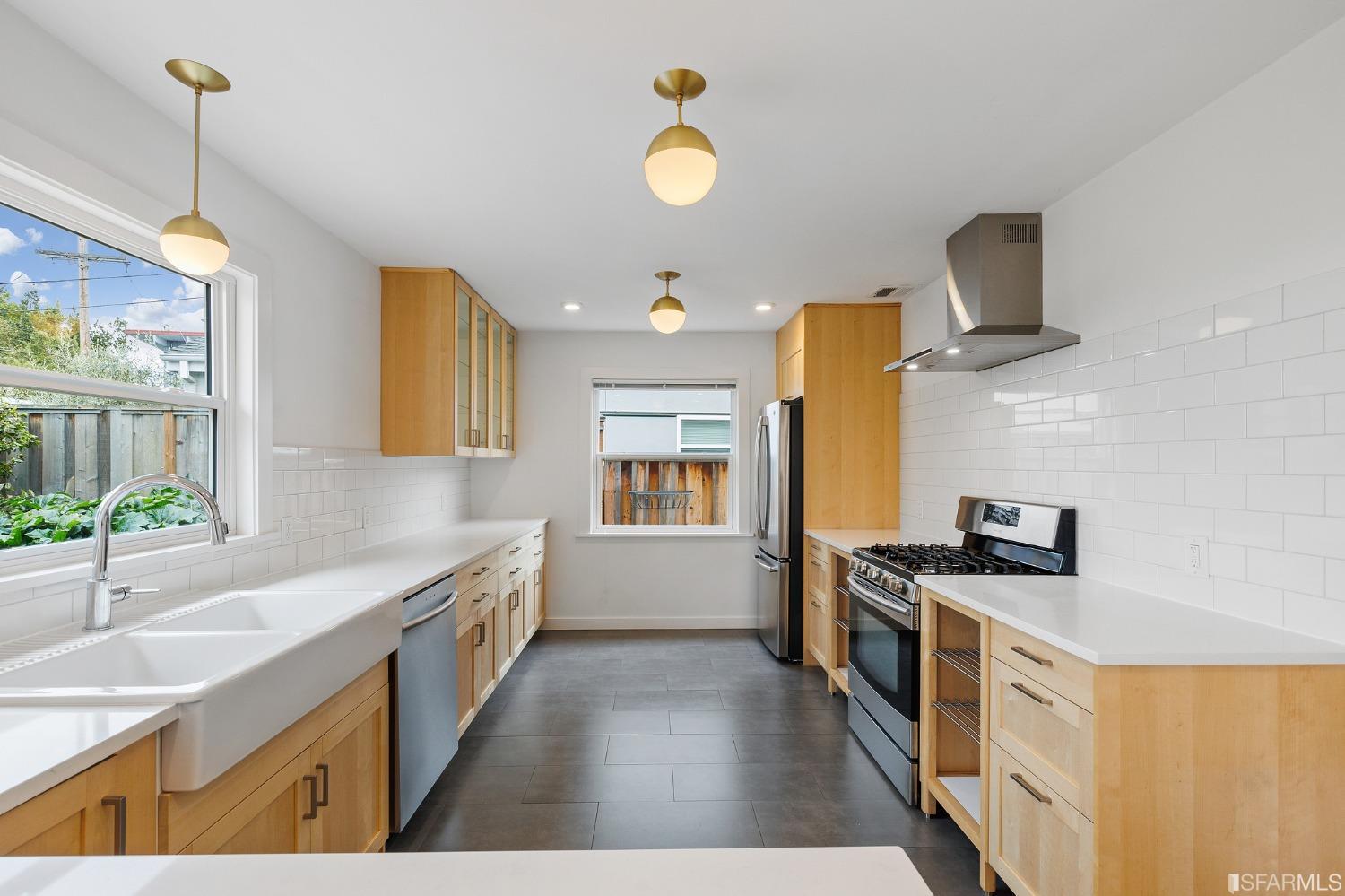 3101 Sunset Terrace San Mateo, CA 94403 - Photo 6 of 24 a kitchen with stainless steel appliances a stove a sink and a refrigerator