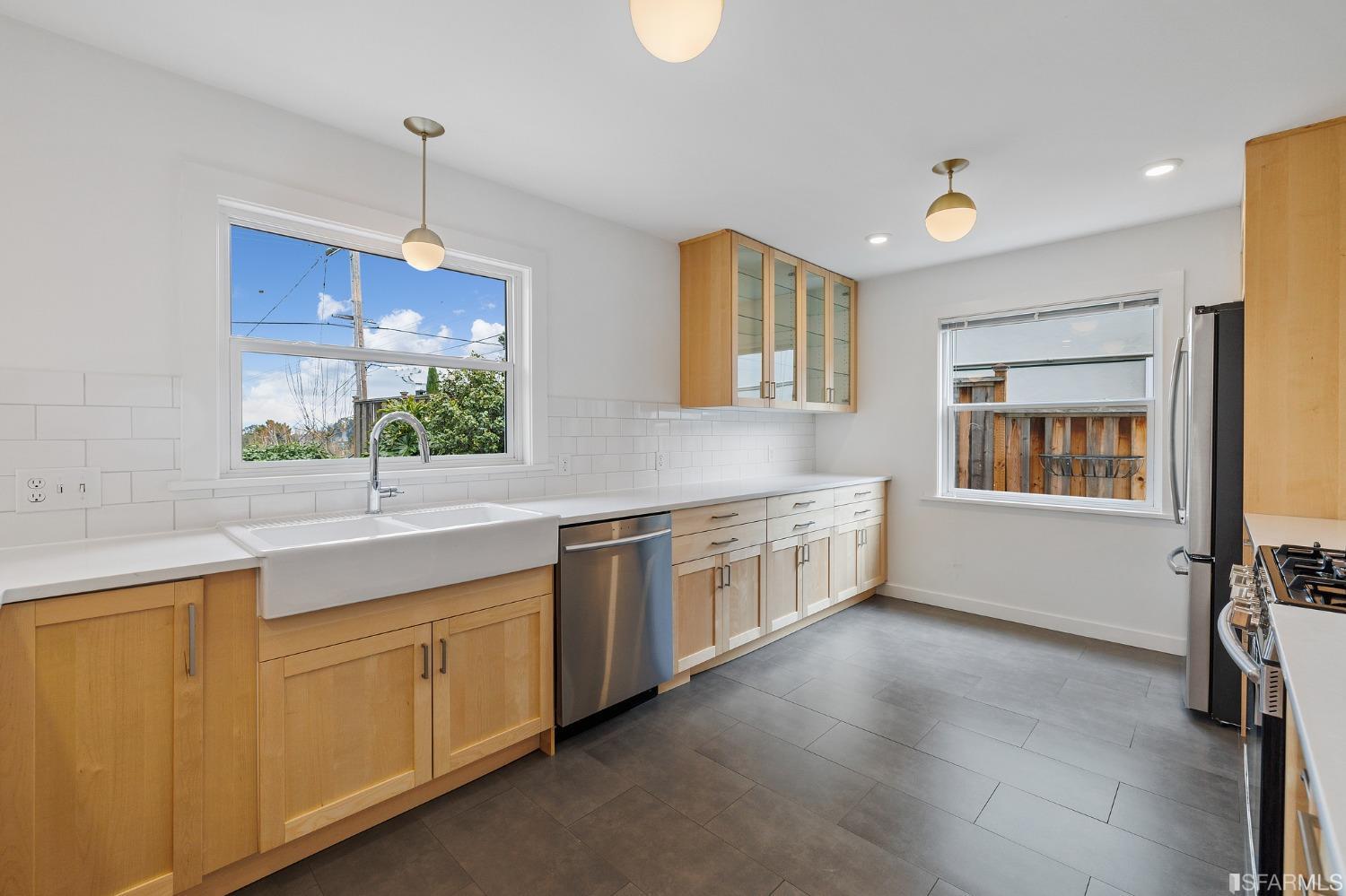 3101 Sunset Terrace San Mateo, CA 94403 - Photo 7 of 24 a large kitchen with kitchen island granite countertop a stove a sink a window and dining table