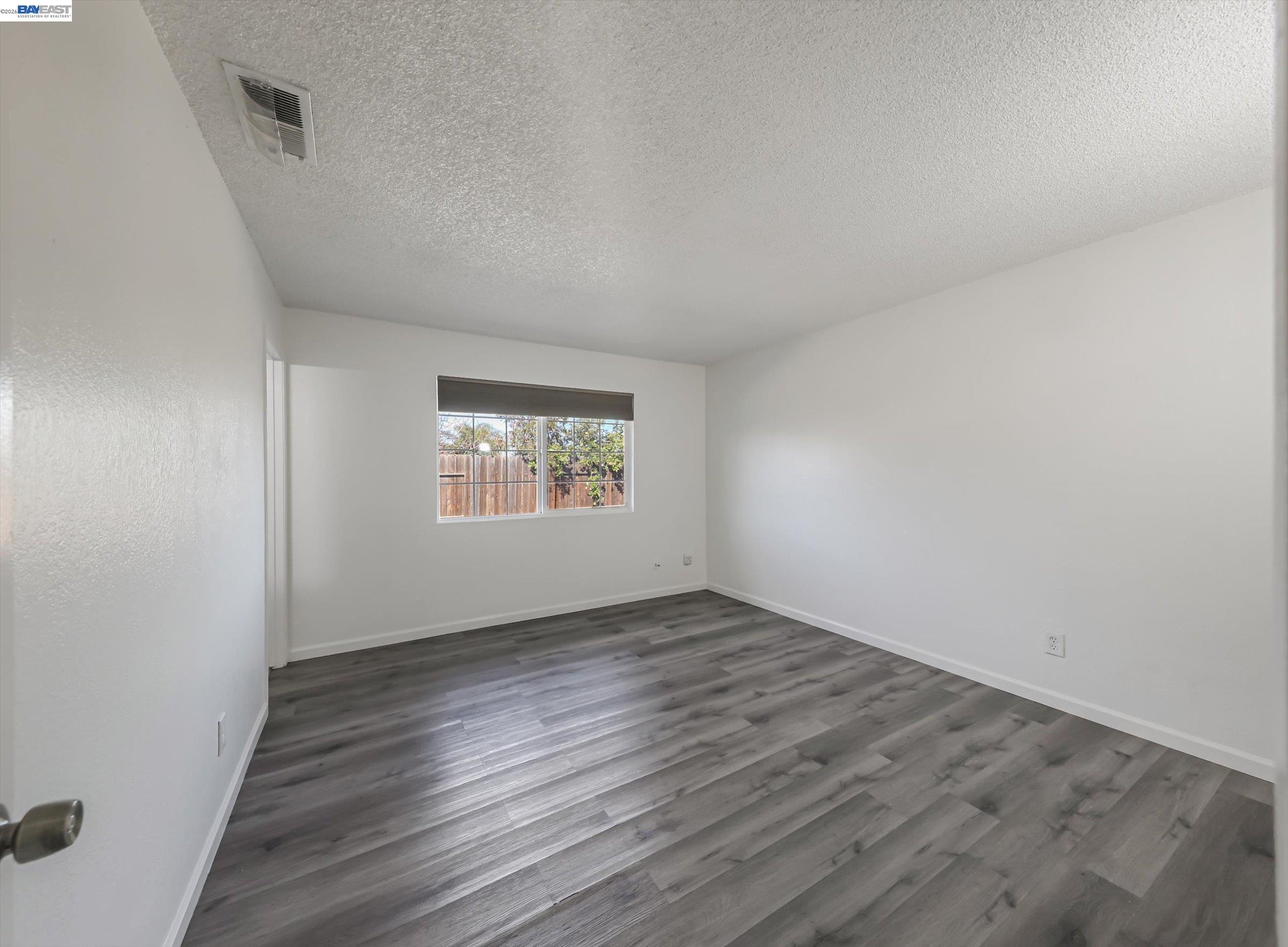 3432 Danielle Place Bay Point, CA 94565 - Photo 21 of 36 an empty room with wooden floor and windows