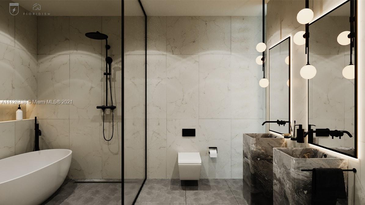 5850 Alton Road Miami Beach, FL 33140 - Photo 18 of 27 a bathroom with a sink a toilet and shower