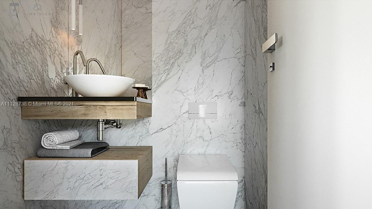 5850 Alton Road Miami Beach, FL 33140 - Photo 7 of 27 a bathroom with a toilet and a sink