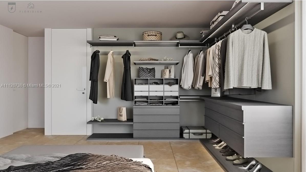 5850 Alton Road Miami Beach, FL 33140 - Photo 9 of 27 a view of walk in closet with clothes and shoes